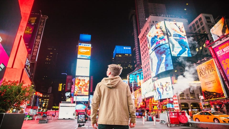 person-standing-near-neon-billboards